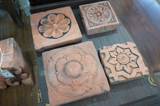Five square terracotta tiles, largest 22 x 23cm